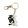 Gold keychain with black and white enamel snakes tangled together